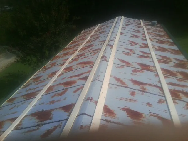 Rusted metal roof panels with new wood purlins before replacement — Storm Damage Roof Repair in Claremont by Roofing Brothers